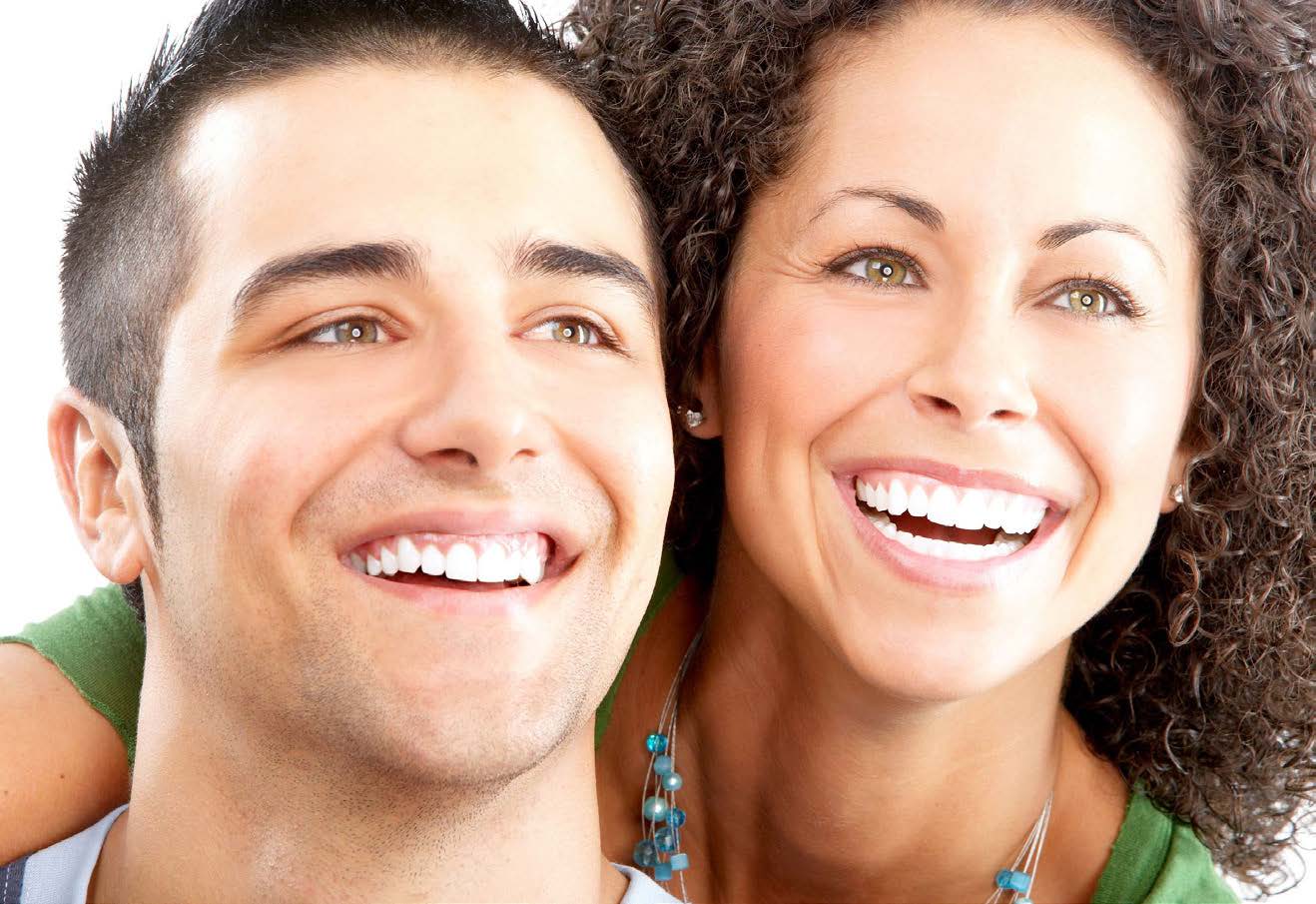 This image features a man and a woman smiling at the camera, with the man on the left and the woman on the right. They appear to be in good spirits and are likely posing for a photograph.