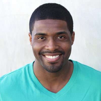 An elderly couple posing for a photo, smiling and embracing each other.